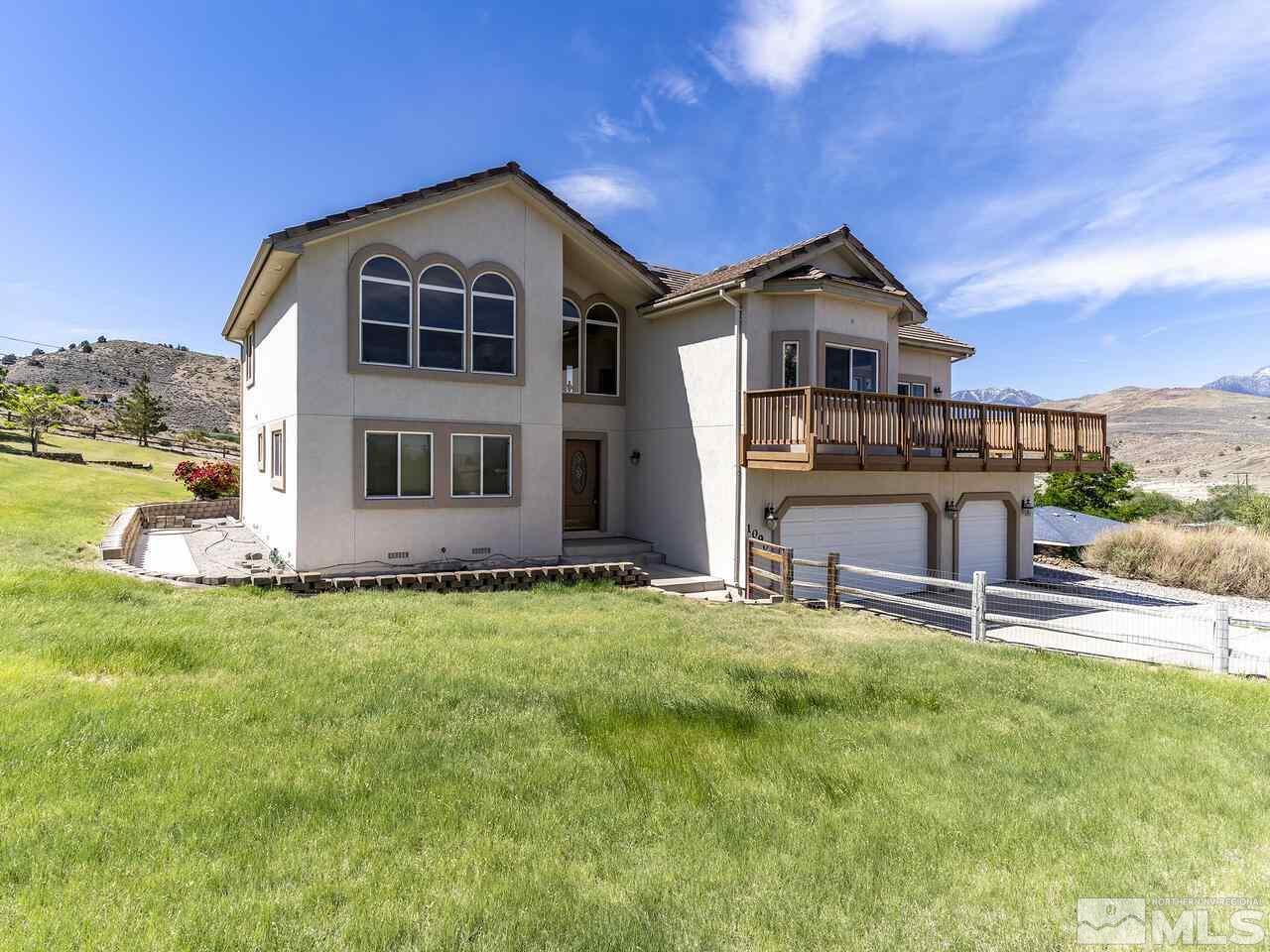 1090 Reese Way Reno, NV 89521 - Photo 26 of 33 a front view of a house with a yard and garage