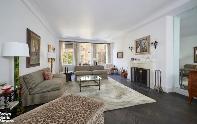 a living room with furniture a fireplace and a window