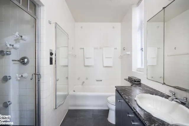 a bedroom with a bed mirror and window