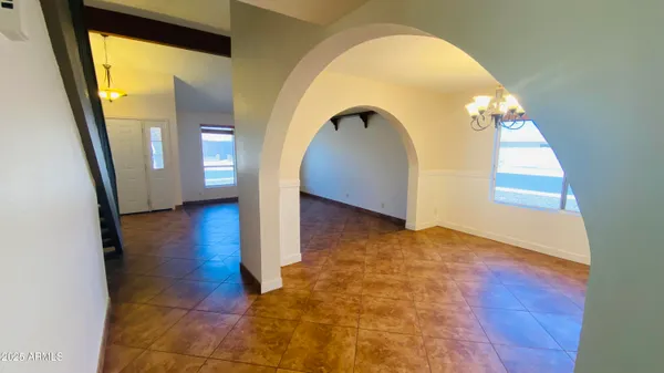 a view of empty room with window and stairs