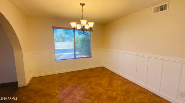 a kitchen with granite countertop a stove a sink and a refrigerator