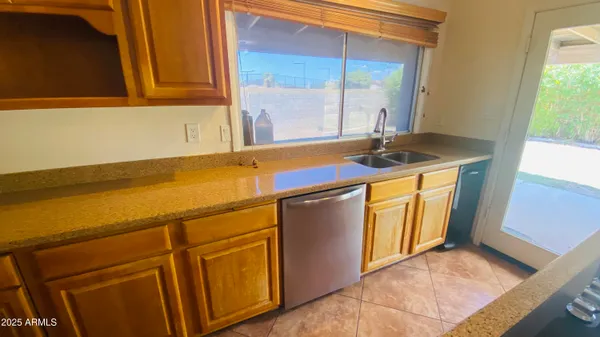 a view of a refrigerator in an empty room