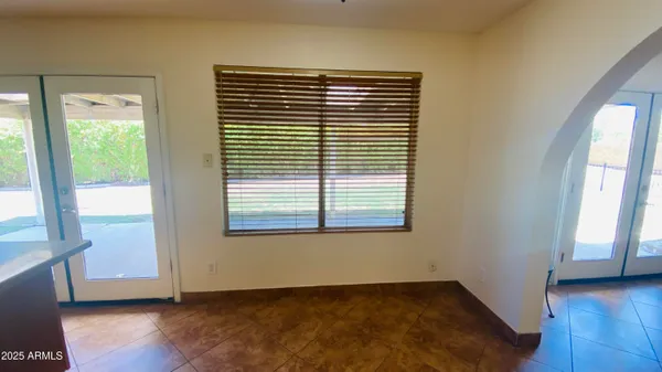 a view of a kitchen with kitchen island wooden cabinets and stainless steel appliances