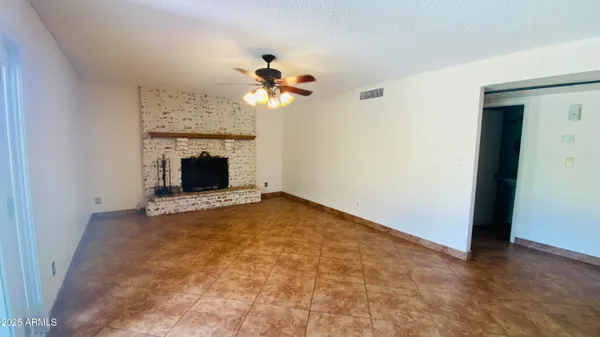 a view of a bedroom with a ceiling fan and a ceiling fan