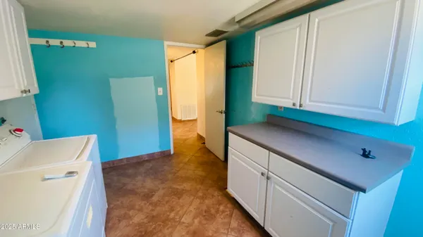 a utility room with a sink a washer and dryer