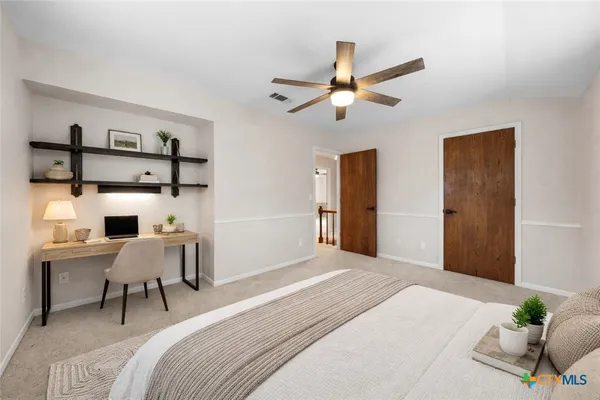 a view of a livingroom with a ceiling fan and window