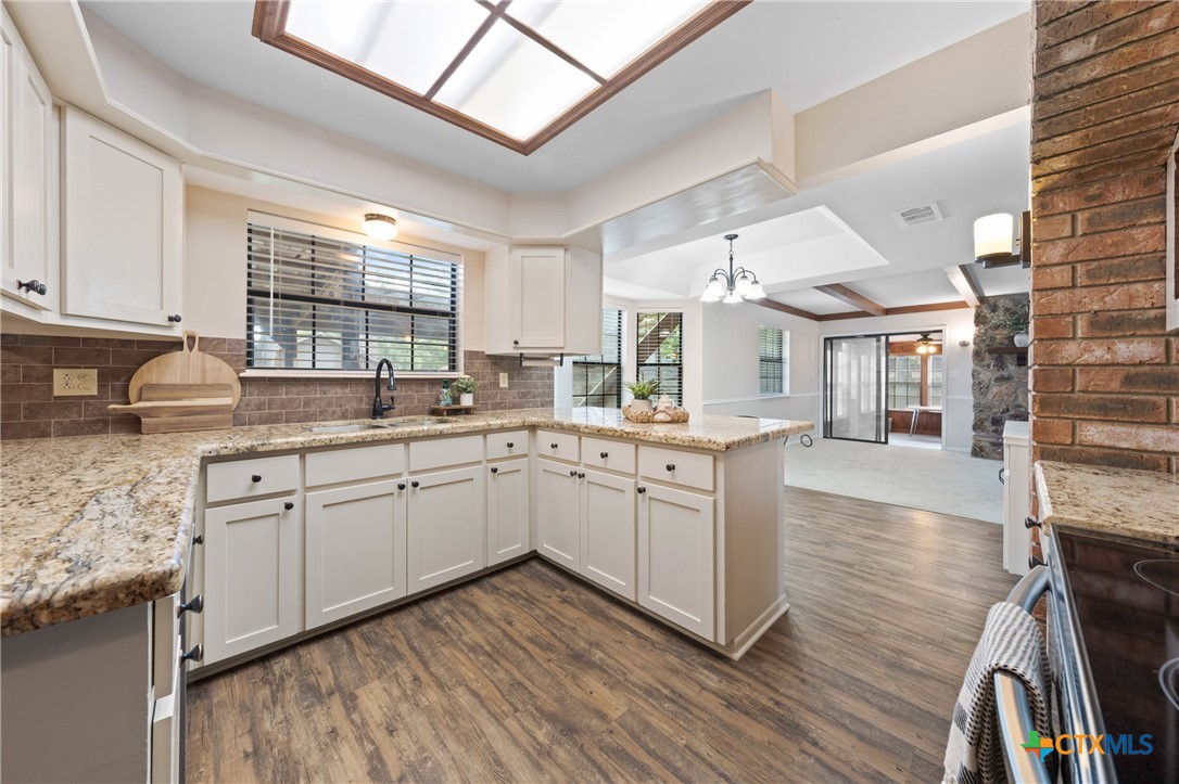 1903 North Harding Avenue Cameron, TX 76520 - Photo 6 of 44 Kitchen with updated countertops, cabinets and backsplash.