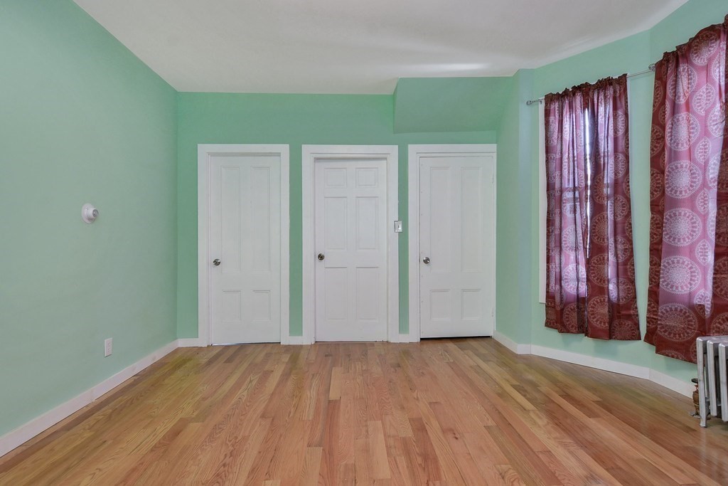 10 Holly Street Lawrence, MA 01841 - Photo 11 of 32 a view of a room with wooden floor and a window
