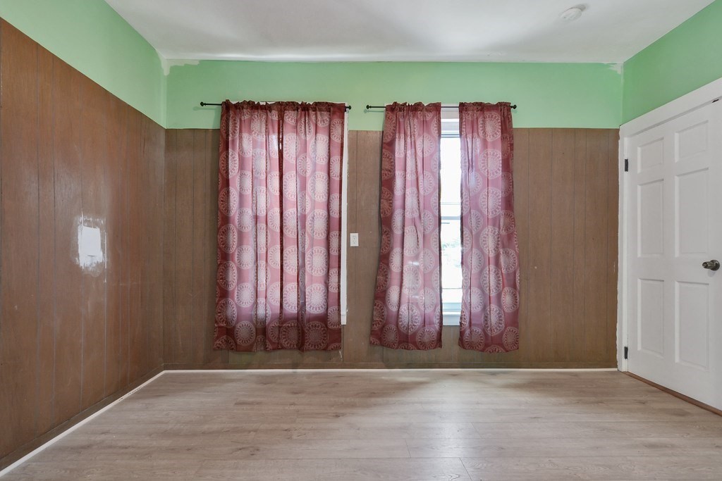 10 Holly Street Lawrence, MA 01841 - Photo 17 of 32 an empty room with wooden floor and windows