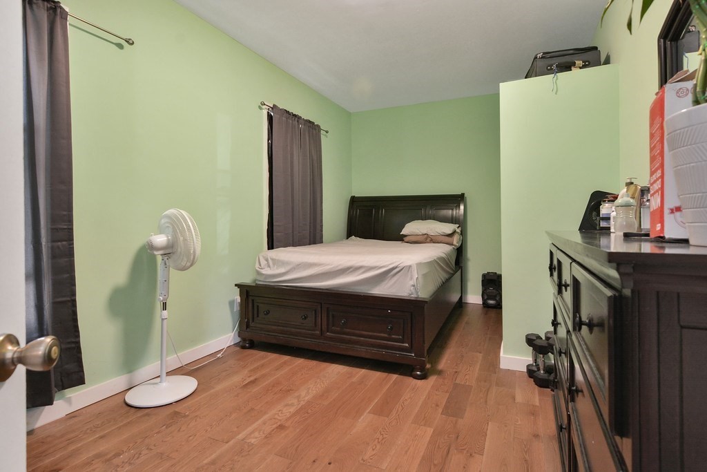 10 Holly Street Lawrence, MA 01841 - Photo 18 of 32 a bedroom with a bed and a flat tv screen on the dresser