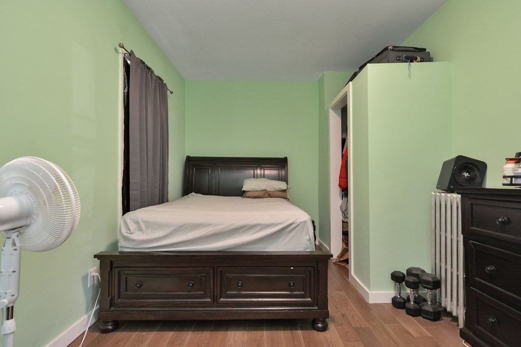 10 Holly Street Lawrence, MA 01841 - Photo 19 of 32 a bedroom with a bed and dresser