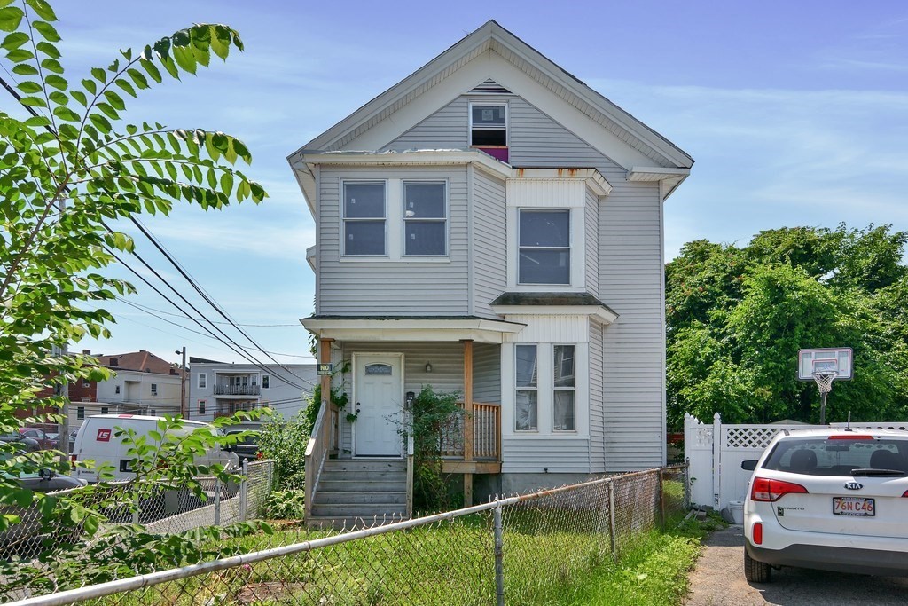 10 Holly Street Lawrence, MA 01841 - Photo 2 of 32 a front view of a house with garden