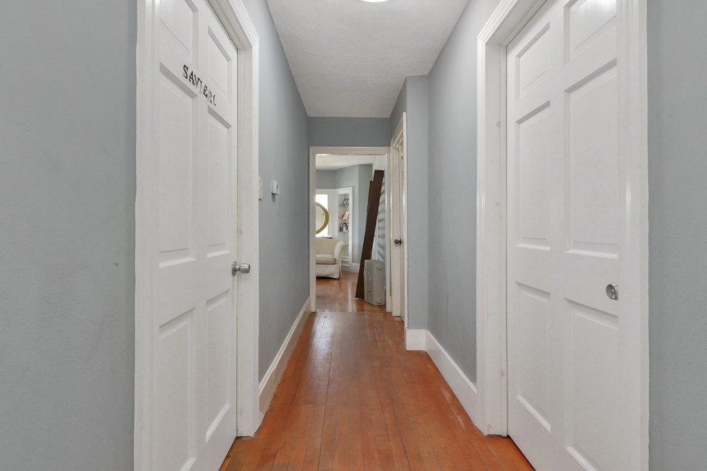 10 Holly Street Lawrence, MA 01841 - Photo 22 of 32 a view of a hallway with wooden floor