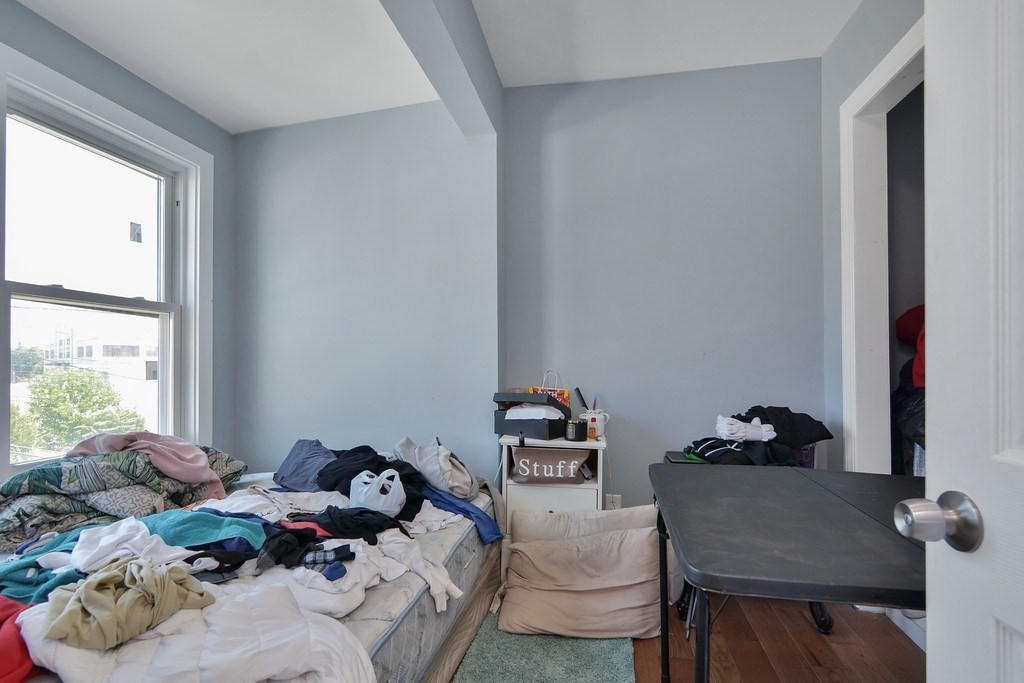 10 Holly Street Lawrence, MA 01841 - Photo 25 of 32 a bedroom with a bed and a window