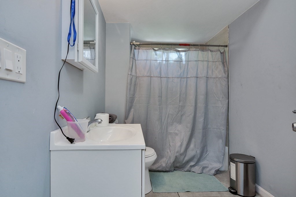 10 Holly Street Lawrence, MA 01841 - Photo 28 of 32 a bathroom with a sink and a mirror