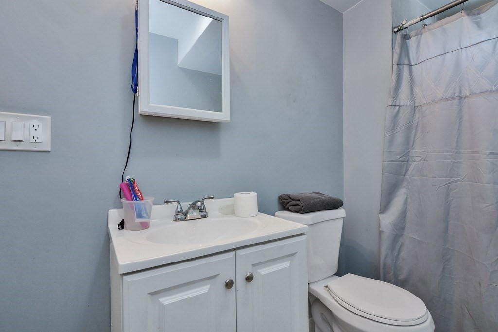 10 Holly Street Lawrence, MA 01841 - Photo 29 of 32 a bathroom with a sink toilet and vanity