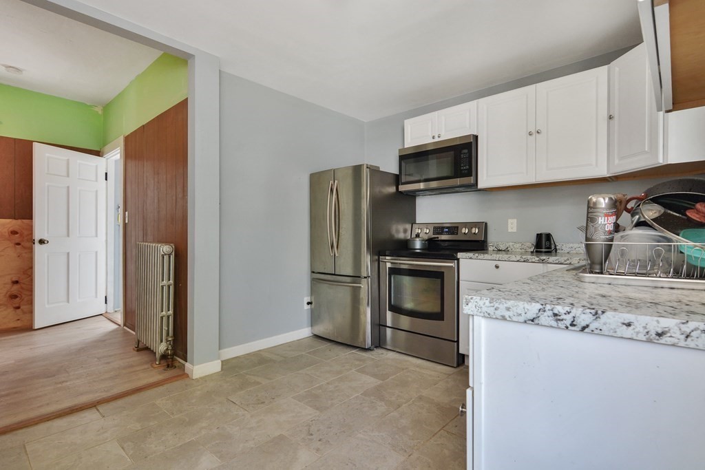 10 Holly Street Lawrence, MA 01841 - Photo 4 of 32 a kitchen with stainless steel appliances granite countertop a refrigerator sink and stove