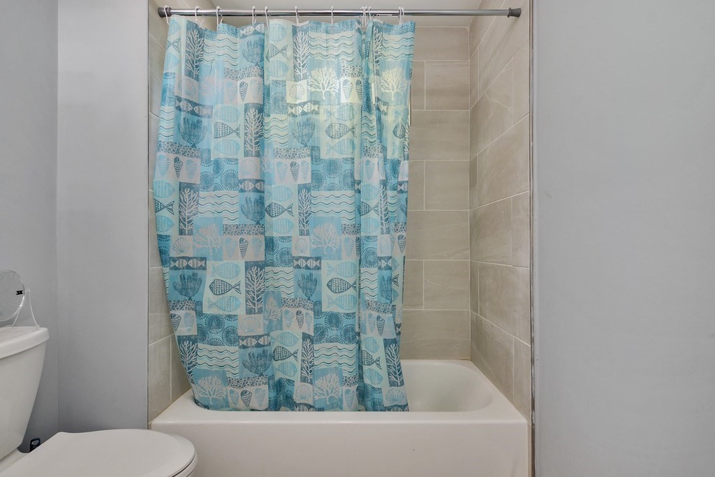 10 Holly Street Lawrence, MA 01841 - Photo 8 of 32 a bathroom with a bathtub and shower