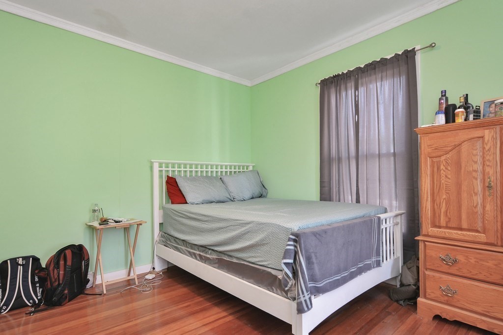 10 Holly Street Lawrence, MA 01841 - Photo 10 of 32 a bedroom with a bed and wooden floor