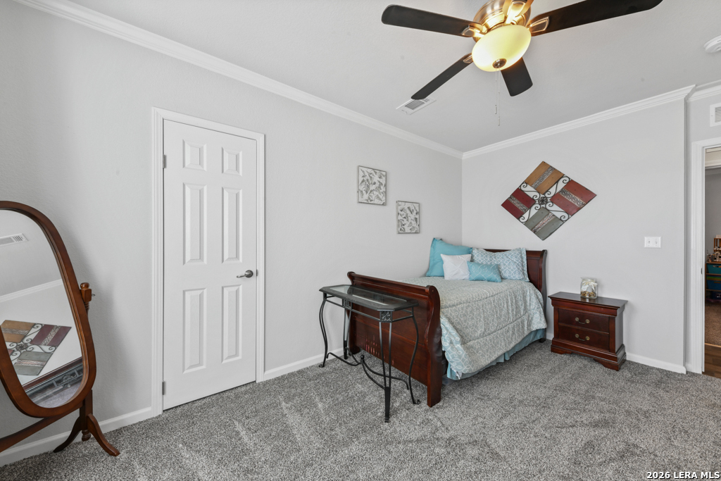 175 Ranch Country Drive La Vernia, TX 78121 - Photo 24 of 49 a spacious bedroom with a bed and a chandelier
