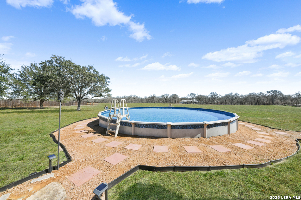 175 Ranch Country Drive La Vernia, TX 78121 - Photo 34 of 49 a view of a swimming pool with a yard