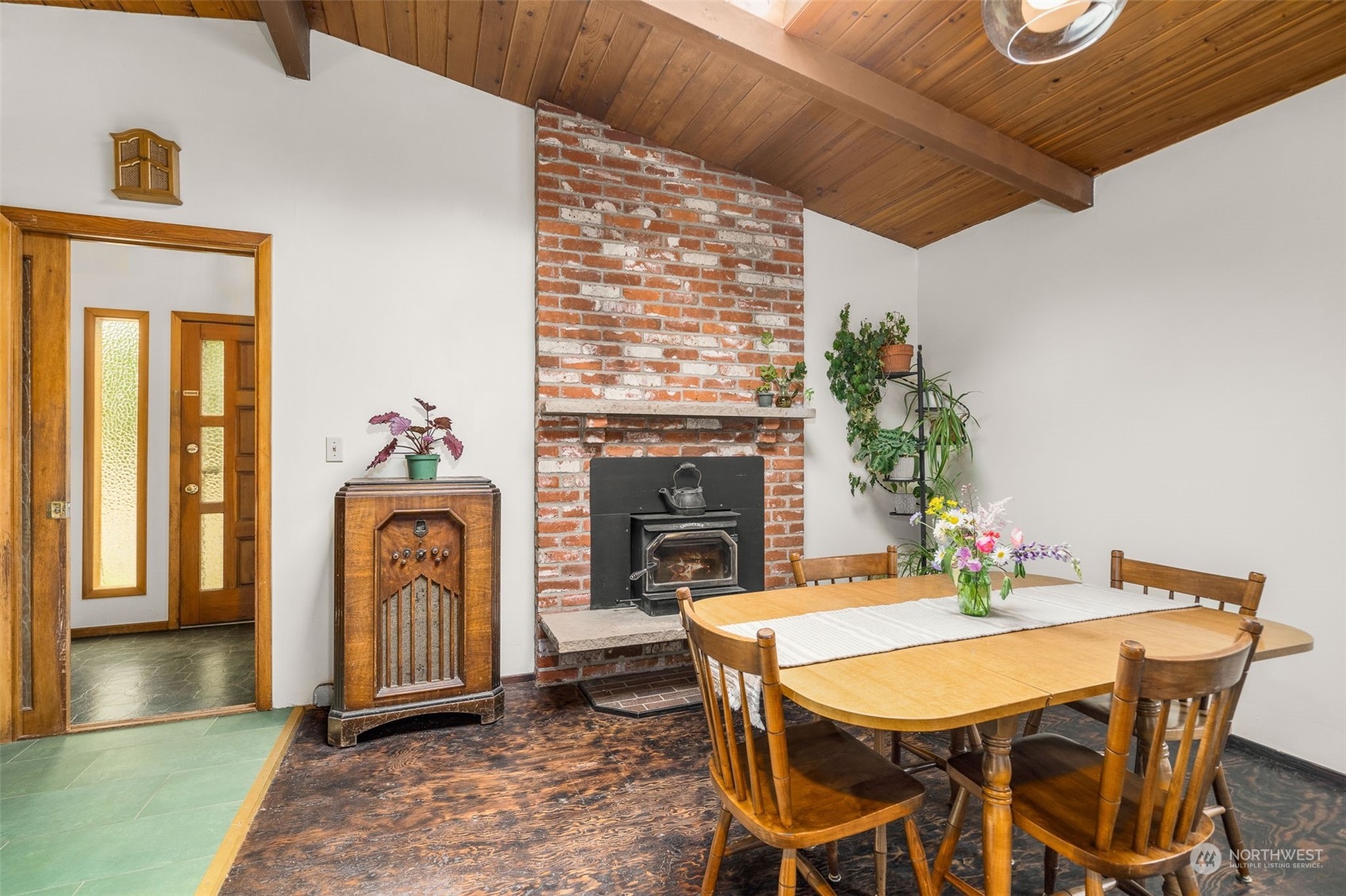 19606 Northwest 11th Avenue Ridgefield, WA 98642 - Photo 13 of 32 a dining room with furniture a fireplace and wooden floor