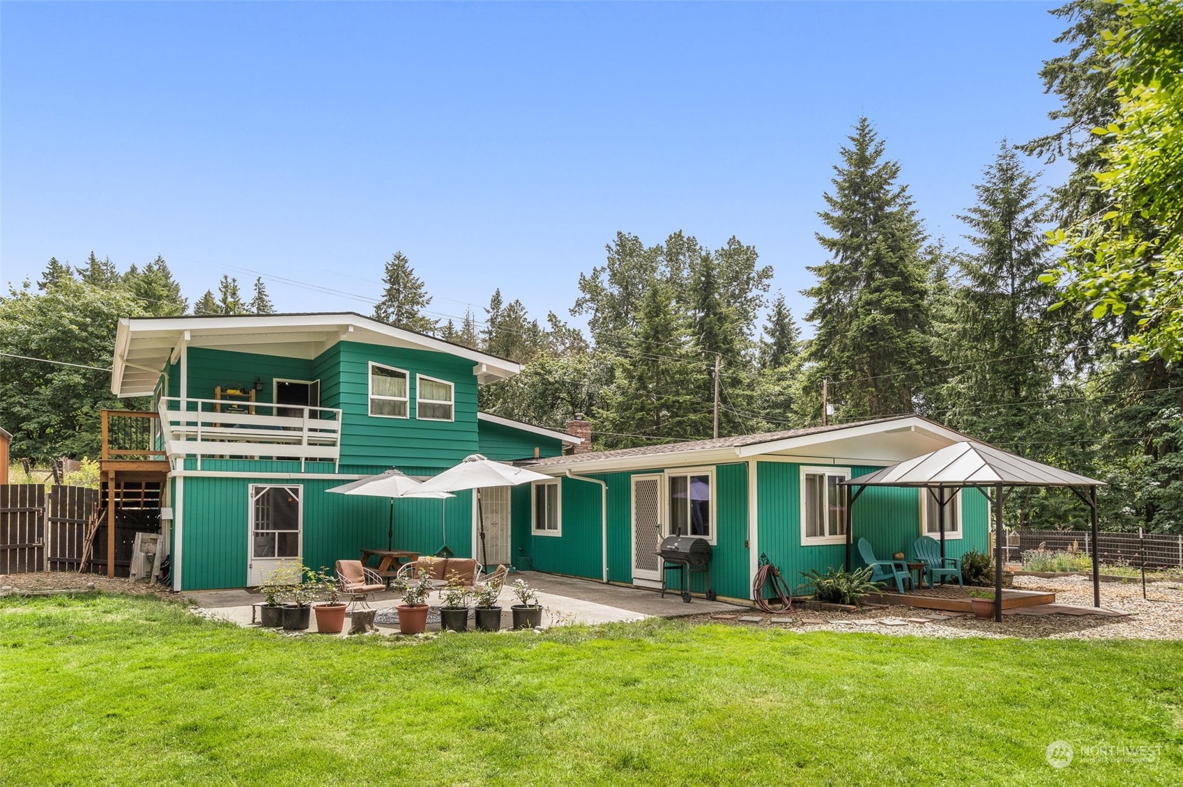 19606 Northwest 11th Avenue Ridgefield, WA 98642 - Photo 23 of 32 a front view of a house with a yard table and chairs