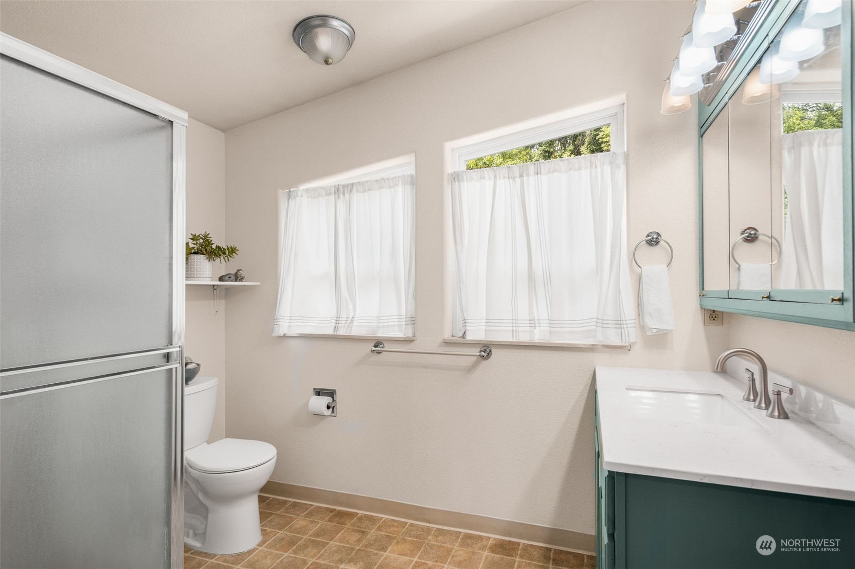 19606 Northwest 11th Avenue Ridgefield, WA 98642 - Photo 8 of 32 a bathroom with a sink a toilet and a mirror
