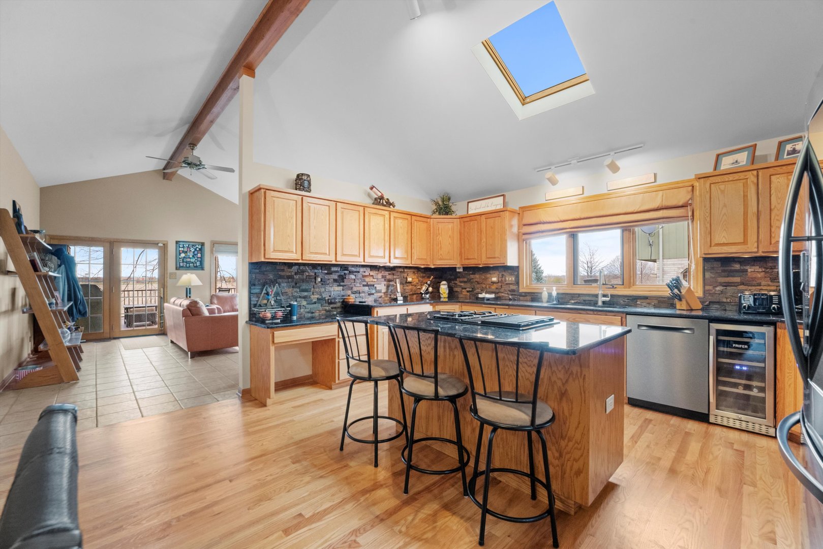 7428 Ridgefield Lane Tinley Park, IL 60487 - Photo 12 of 43 a kitchen with stainless steel appliances wooden floor and chairs