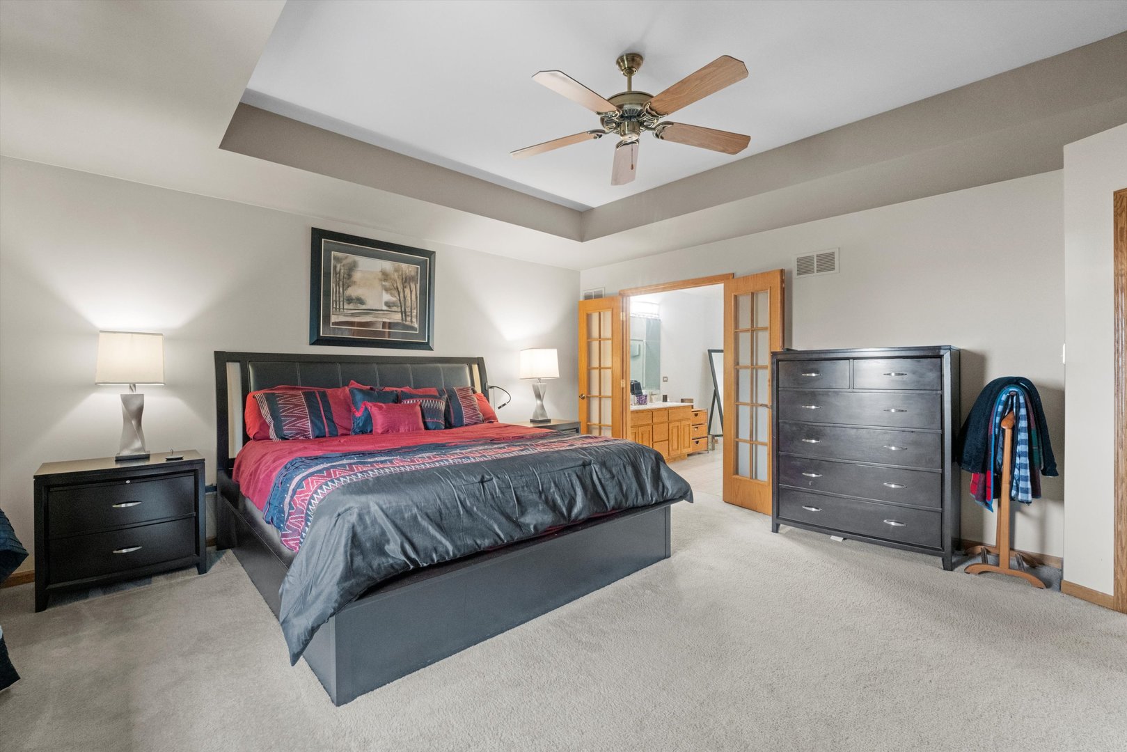 7428 Ridgefield Lane Tinley Park, IL 60487 - Photo 21 of 43 a spacious bedroom with a bed and a chandelier