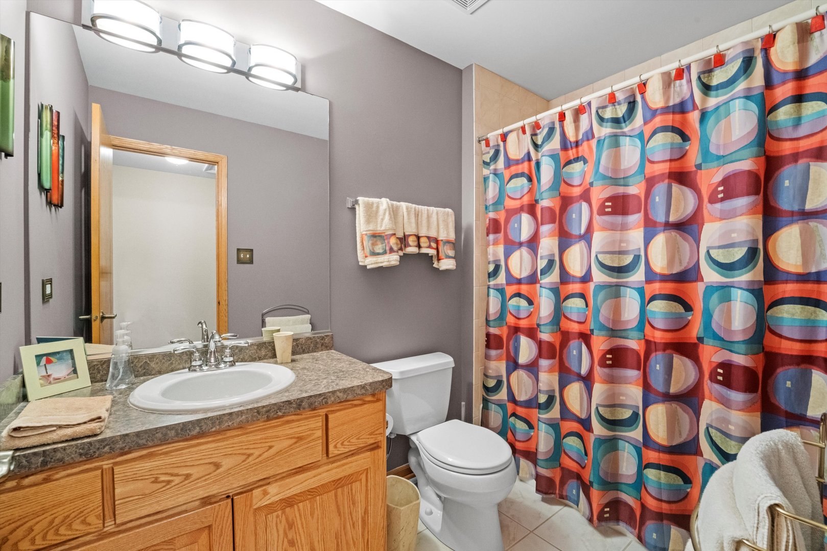 7428 Ridgefield Lane Tinley Park, IL 60487 - Photo 29 of 43 a bathroom with a sink and mirror with toilet