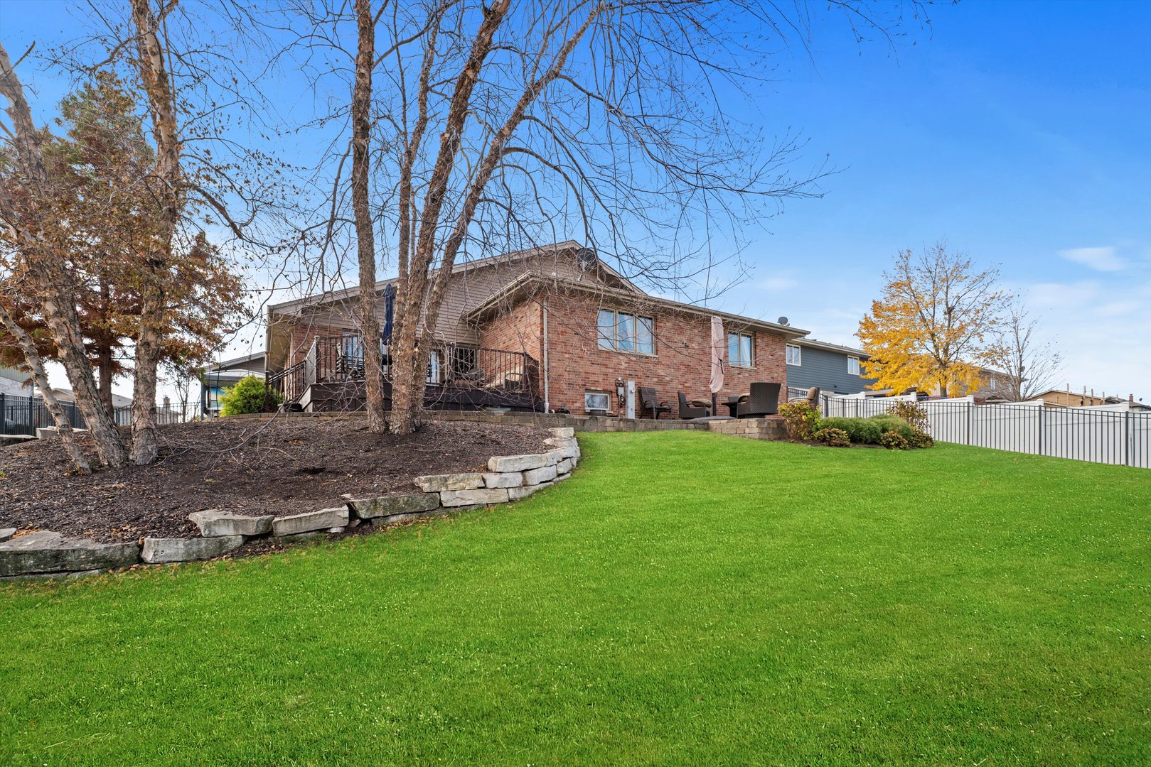 7428 Ridgefield Lane Tinley Park, IL 60487 - Photo 39 of 43 a front view of a house with a garden and trees