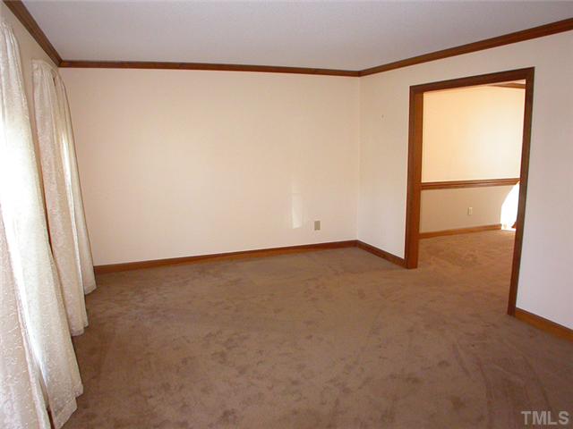 4524 Wingate Drive Raleigh, NC 27609 - Photo 6 of 25 an empty room with a door