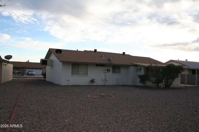 a view of a house with a yard and a car parked