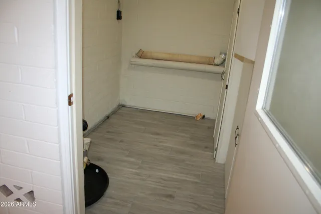 an empty room with closet and a chandelier fan