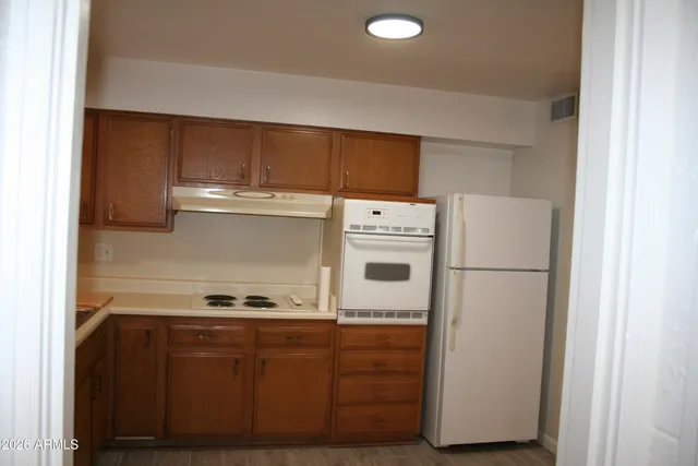 a white refrigerator freezer sitting inside of a kitchen