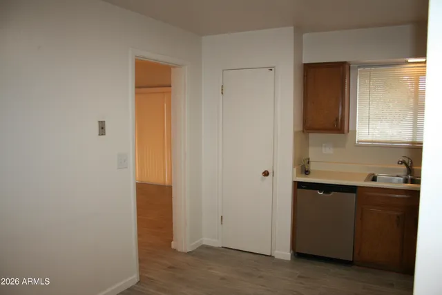 a kitchen with a refrigerator sink and cabinets