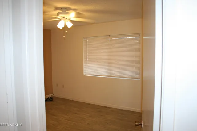 a view of an empty room and wooden floor