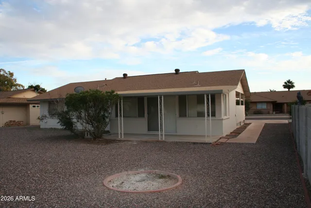 a view of a house with a backyard