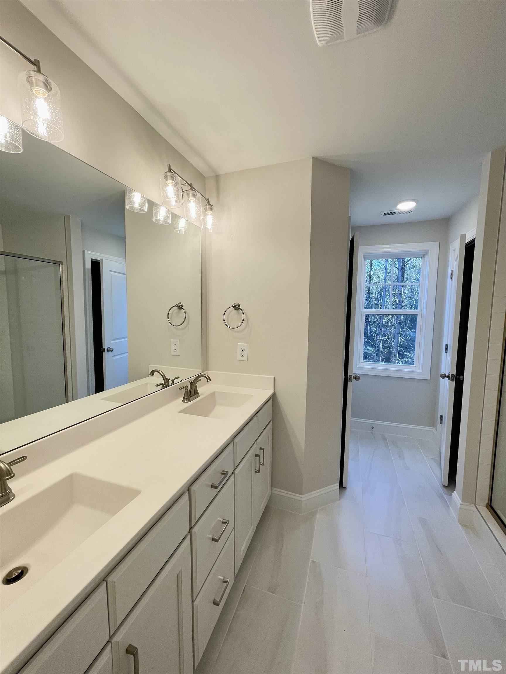 35 Mulberry Road Spring Hope, NC 27882 - Photo 17 of 32 a spacious bathroom with a double vanity sink and a mirror