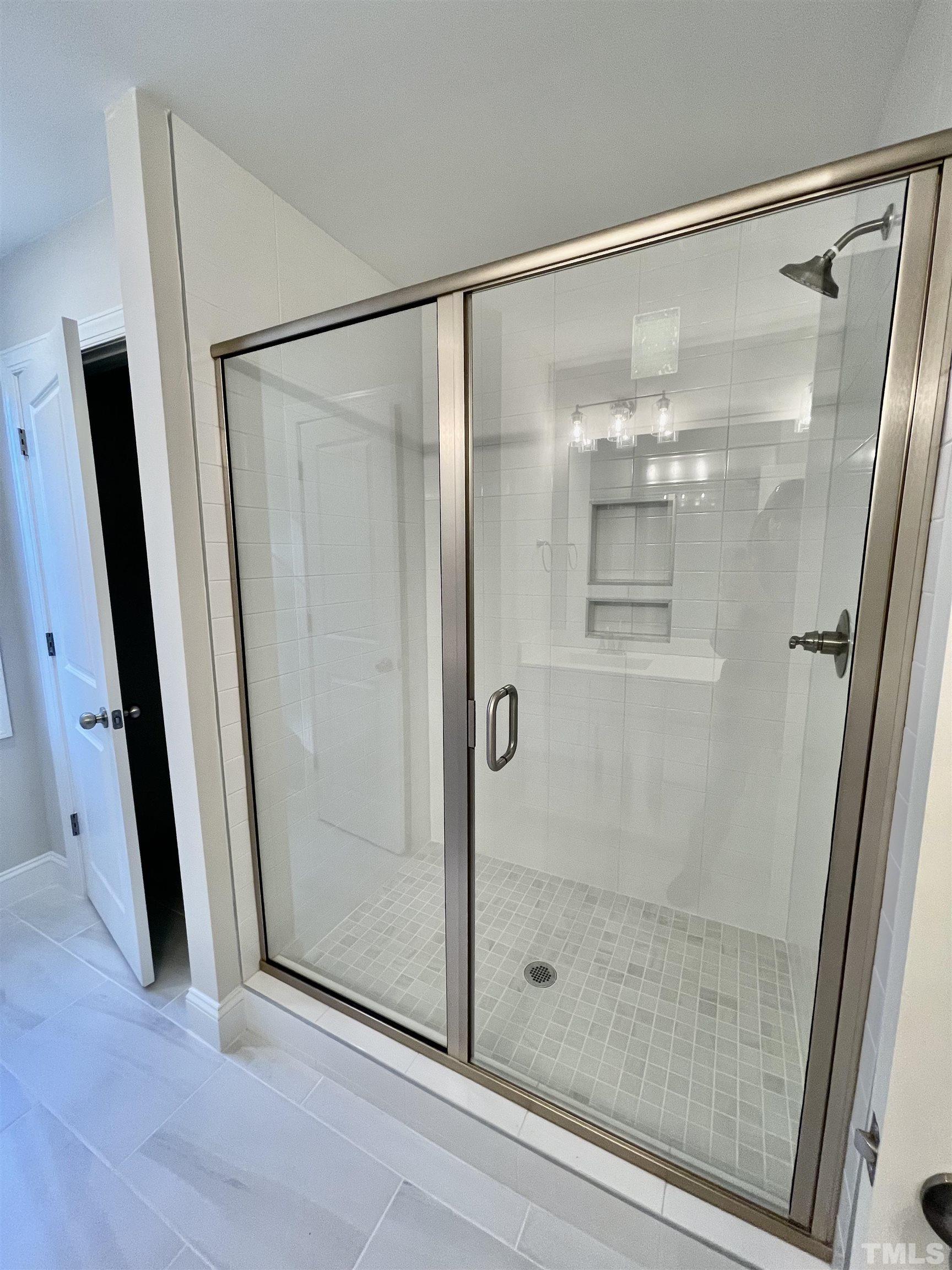 35 Mulberry Road Spring Hope, NC 27882 - Photo 18 of 32 a bathroom with a glass shower door and a window