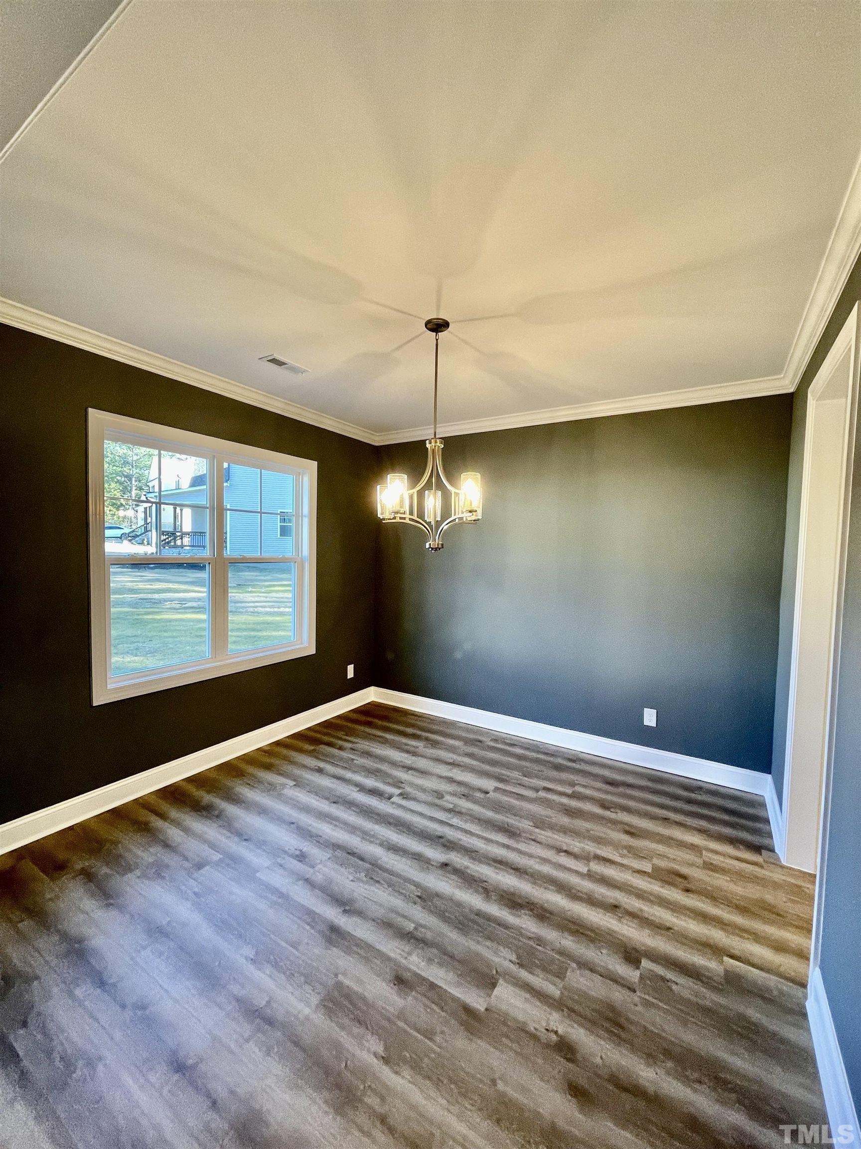 35 Mulberry Road Spring Hope, NC 27882 - Photo 2 of 32 a view of an empty room with window and wooden floor