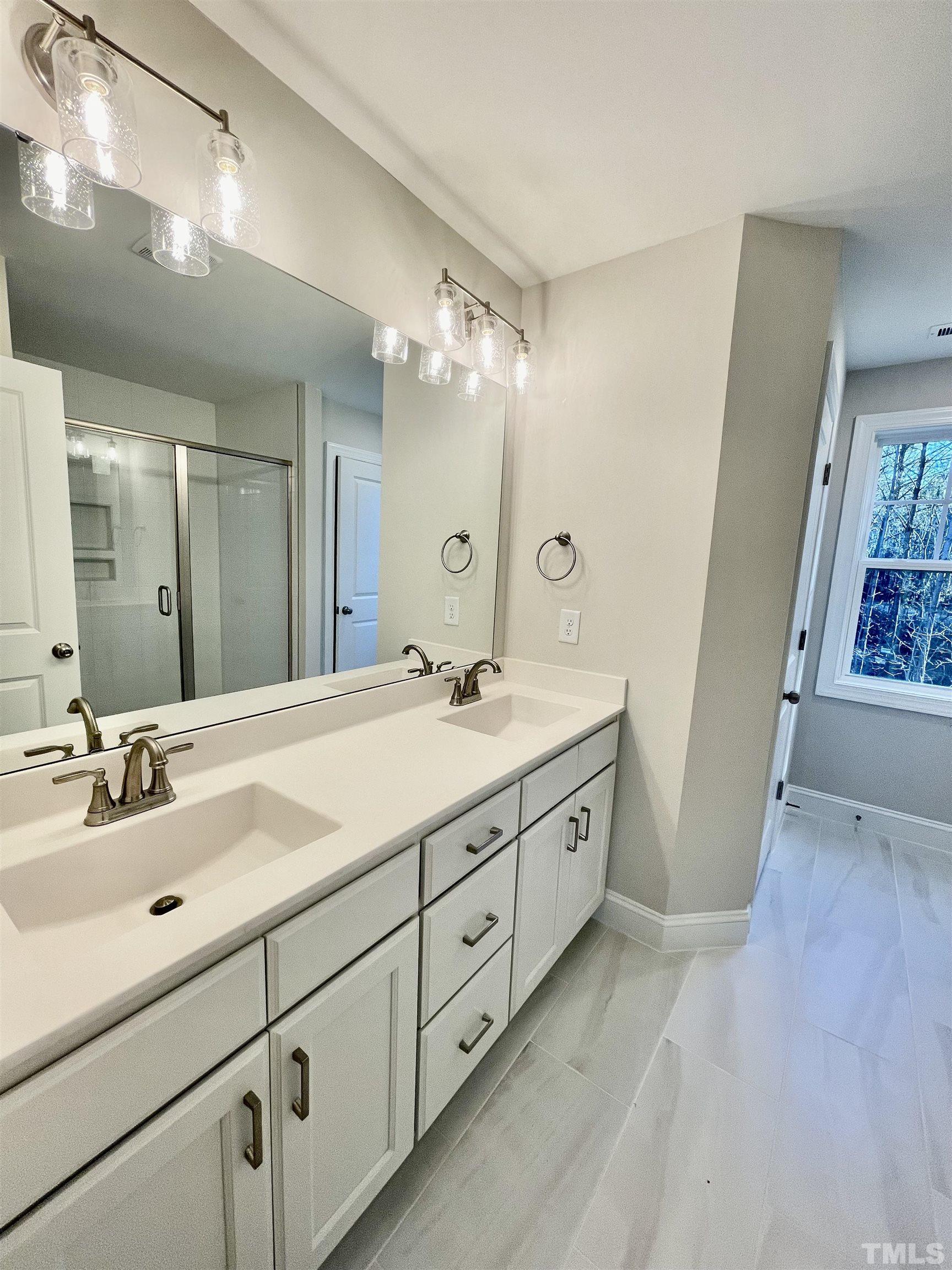 35 Mulberry Road Spring Hope, NC 27882 - Photo 22 of 32 a spacious bathroom with double sink and a mirror