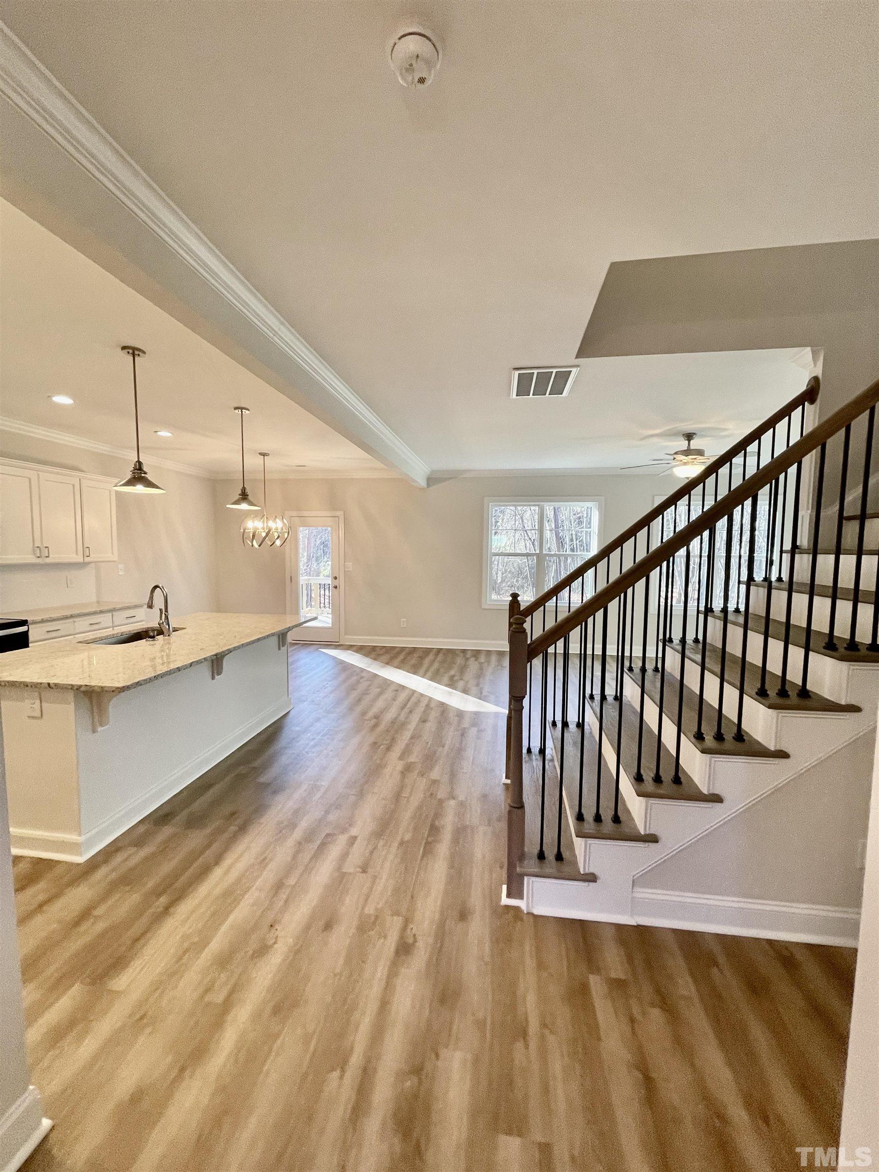 35 Mulberry Road Spring Hope, NC 27882 - Photo 3 of 32 a view of staircase and kitchen with wooden floor