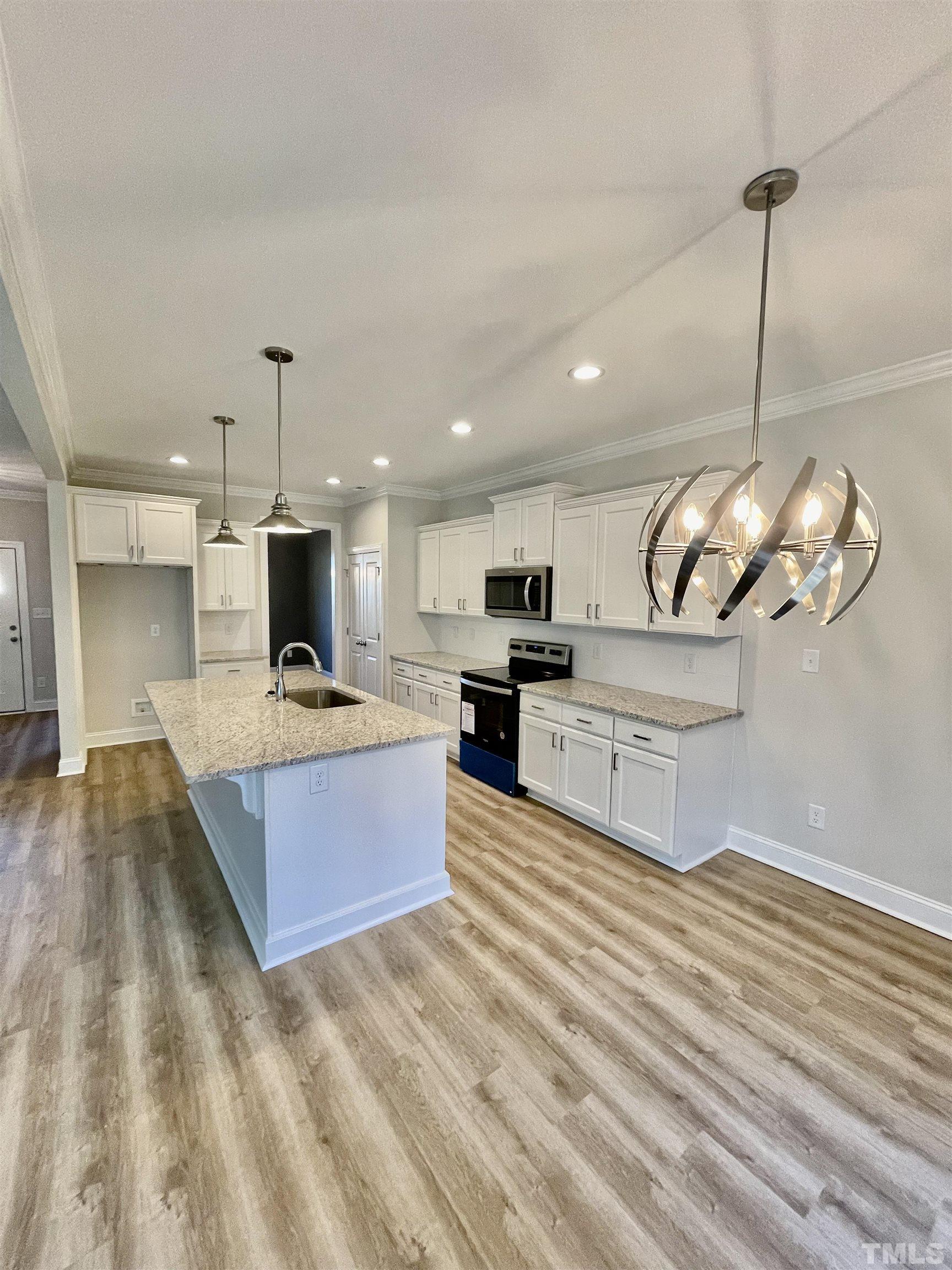35 Mulberry Road Spring Hope, NC 27882 - Photo 5 of 32 a large kitchen with stainless steel appliances kitchen island a large counter space a sink and cabinets
