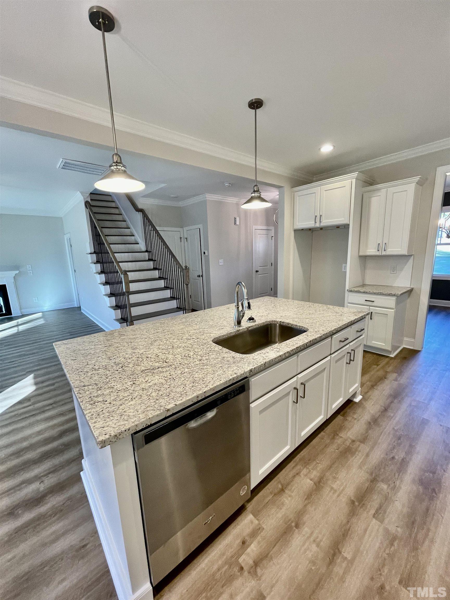 35 Mulberry Road Spring Hope, NC 27882 - Photo 6 of 32 a kitchen with stainless steel appliances granite countertop a sink a refrigerator a stove a kitchen island and chairs