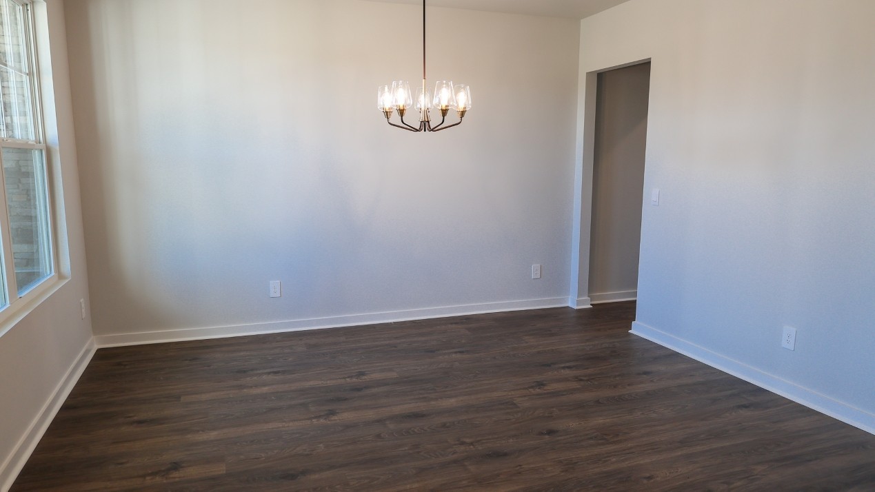 308 Harvest Point Boulevard Spring Hill, TN 37174 - Photo 10 of 91 a view of an empty room with wooden floor and a window