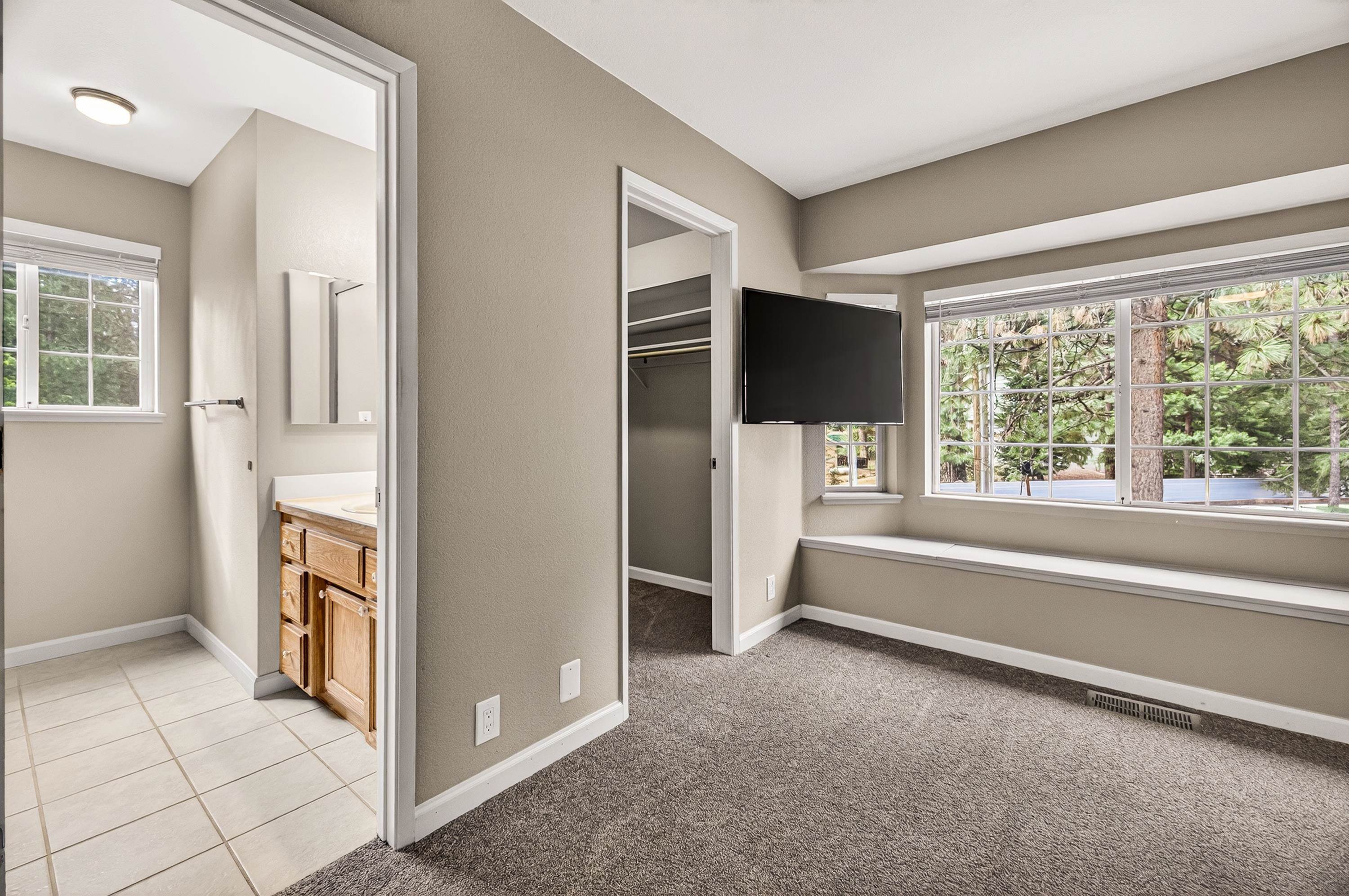811 Golf Club Road Lake Almanor, CA 96137 - Photo 20 of 42 a view of an empty room with a fireplace and a window