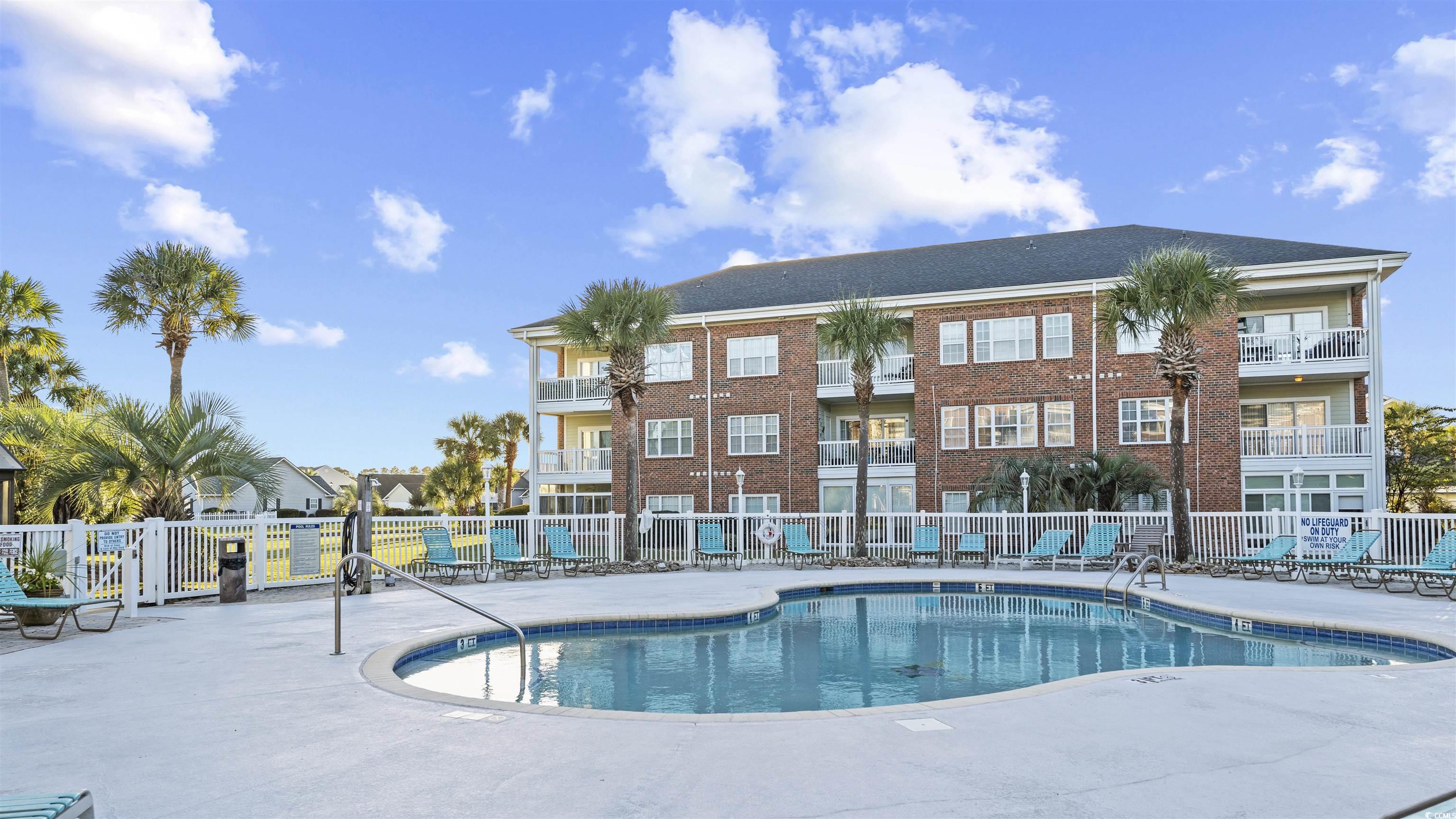 3931 Gladiola Court, Unit 303 Myrtle Beach, SC 29588 - Photo 24 of 26 Community pool with a patio area