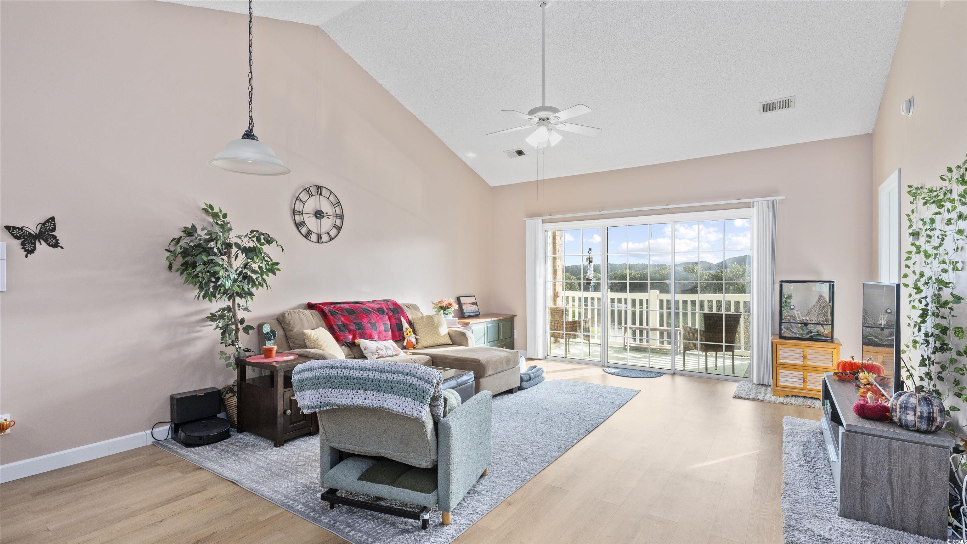 3931 Gladiola Court, Unit 303 Myrtle Beach, SC 29588 - Photo 4 of 26 Living room with light wood-type flooring, a ceiling fan, and high vaulted ceiling